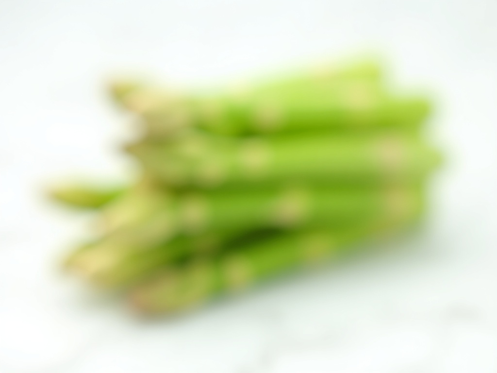Fresh green asparagus spears bundled on white marble surface